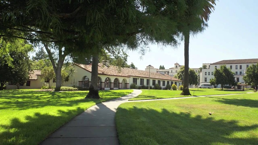 a wide angle photograph of the Yountville veterans home with a large field of grass in the foreground
